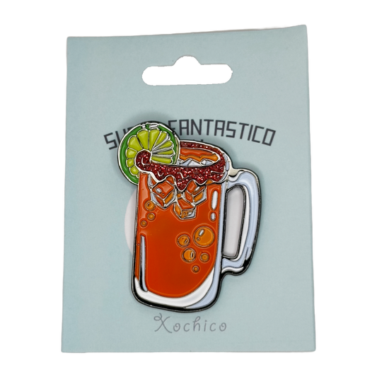 Enamel lapel pin shaped like a Michelada in a beer stein with glitter "tajin" rim and lime garnish.