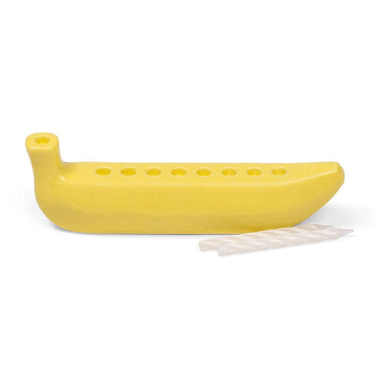 Yellow ceramic banana with 8 holes to put candles in for Hanukkah on a white background
