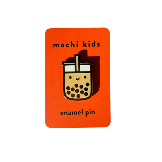 Enamel pin with a bubble tea design on an orange card labeled 'mochi kids'.