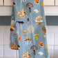 Light blue kitchen towel with various types of mushrooms on it 