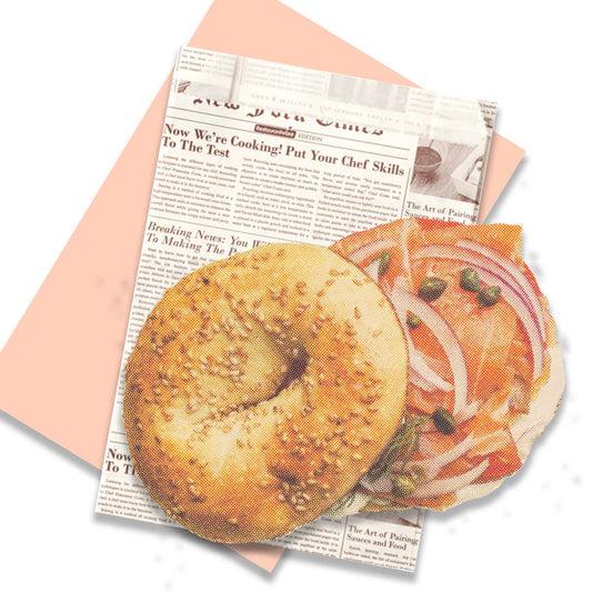 Bagel and lox designed post card on top of a newspaper envelope background