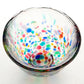 Sake glass cup with multicolored dot pattern on a white background