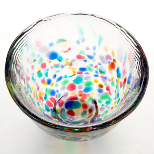 Sake glass cup with multicolored dot pattern on a white background
