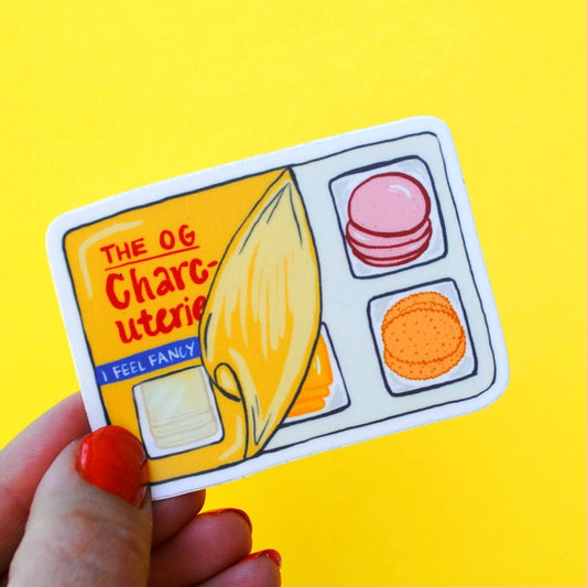 Sticker of a the og charcuterie aka lunchables -- design is a partially peeled back plastic covering on the snack tray, showing the sliced meat, crackers and cheese