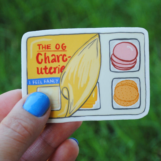 Sticker of a the og charcuterie aka lunchables -- design is a partially peeled back plastic covering on the snack tray, showing the sliced meat, crackers and cheese