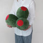 Person holding three green olive pillows 
