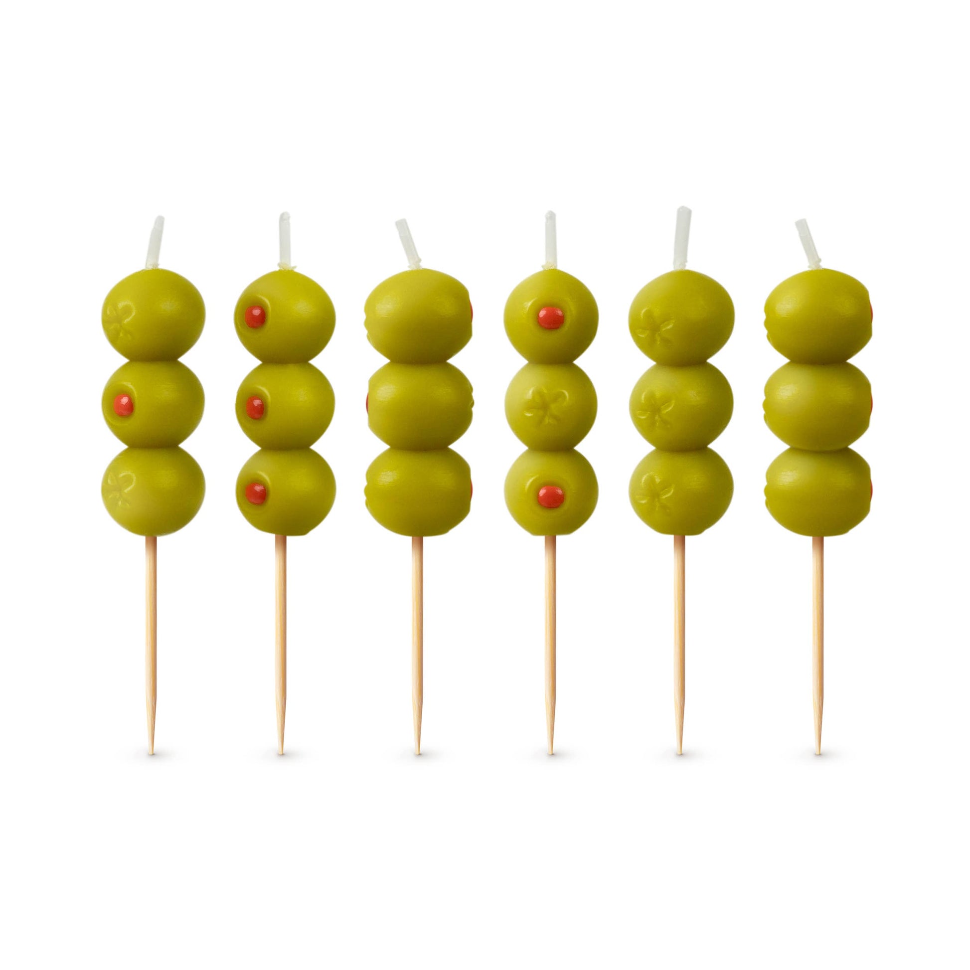 Six skewers with green olives and red stones on a white background
