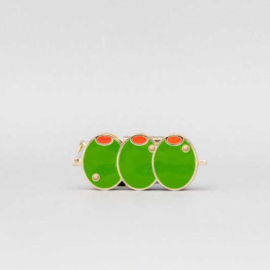 Three green circular earrings with red centers on a white background