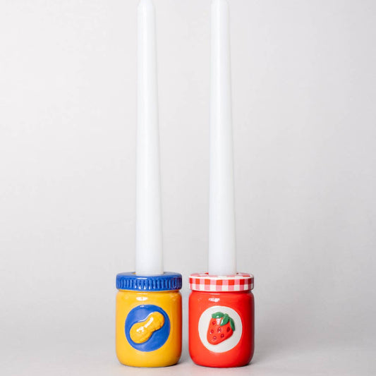 Peanut Butter and Jelly ceramic candle holders with white tapered candles inside.