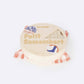 A round package of socks that look like Petit Camembert cheese on a plain white background, wrapped in a red-and-white checkered paper band.