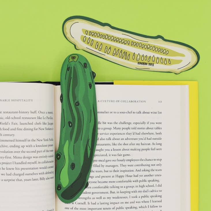 Image showcasing both sides of pickle bookmark -- one side shows a whole dill pickle while the other shows it sliced in half