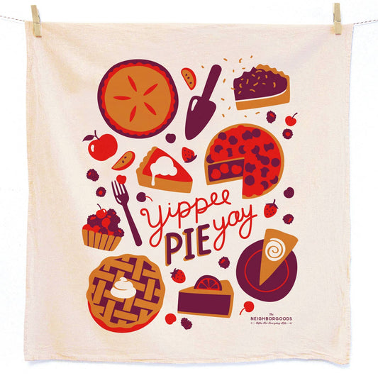 Kitchen towel that says Yippee Pie Yay with whole, sliced and segmented pies, berries, pie server and forks.