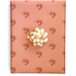 Pink wrapping paper with pink prawns on it with cream colored bow