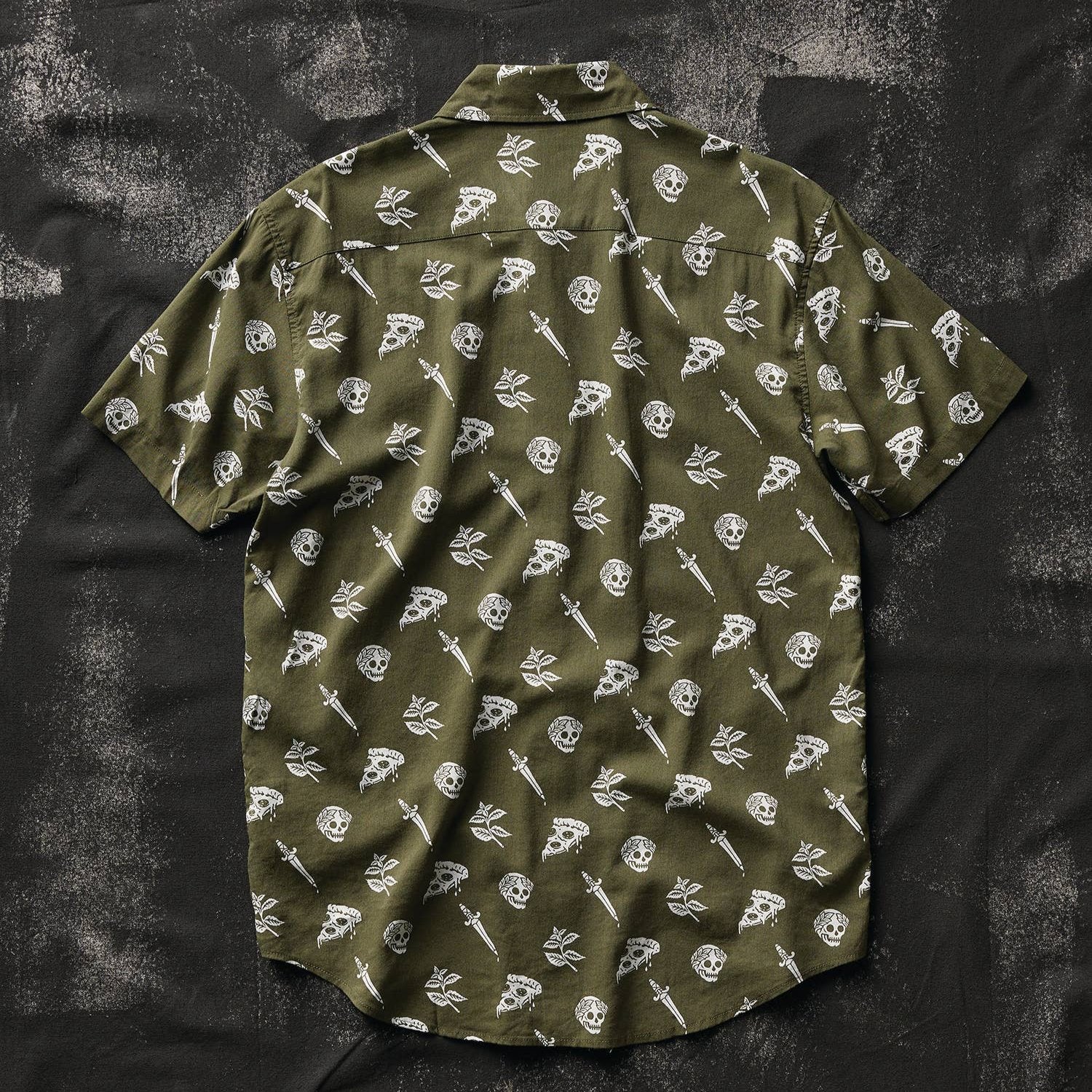 Back side of a button up shirt that is oregano green with skulls, pizza and swords on it. 