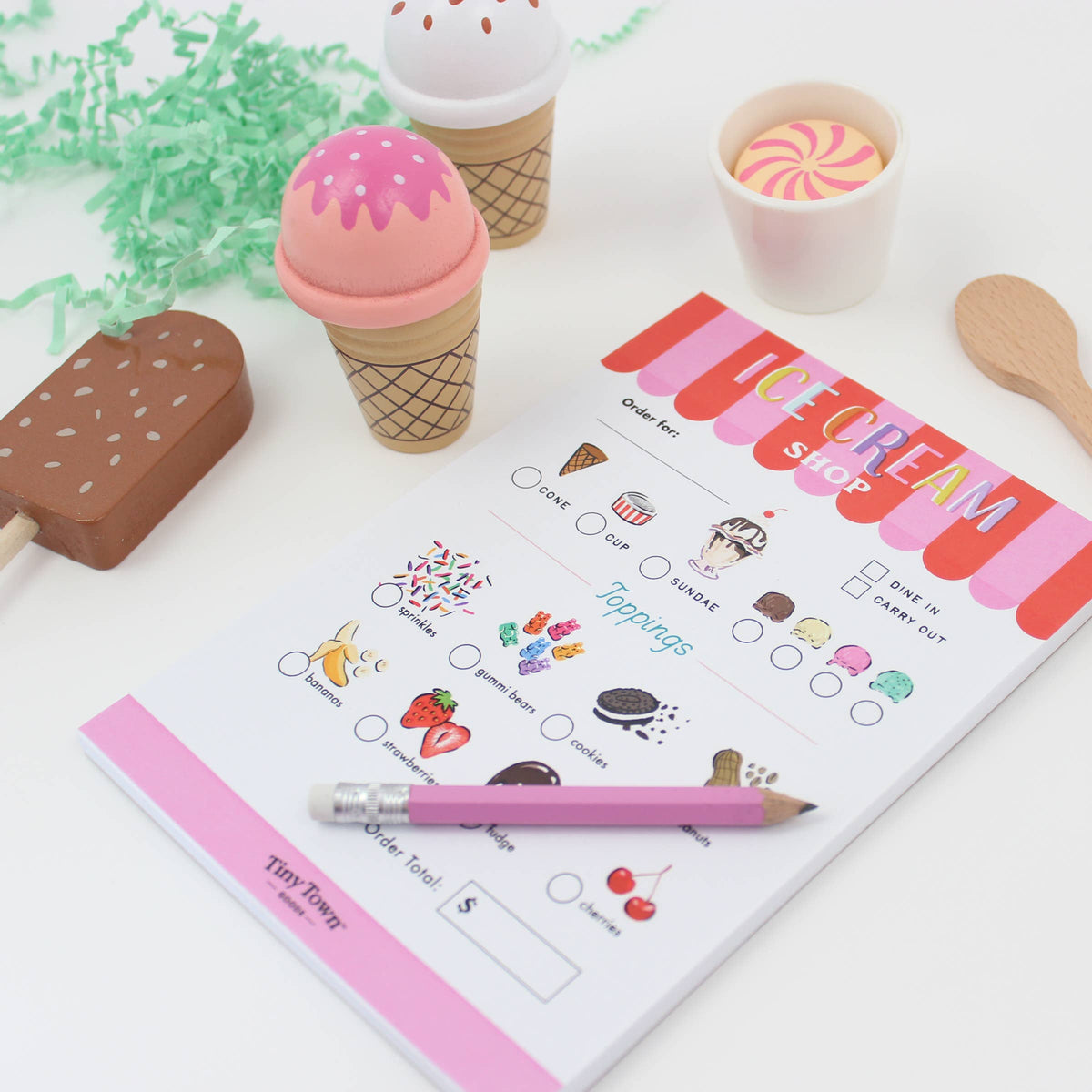 Ice cream-themed children's menu with toys on a white surface