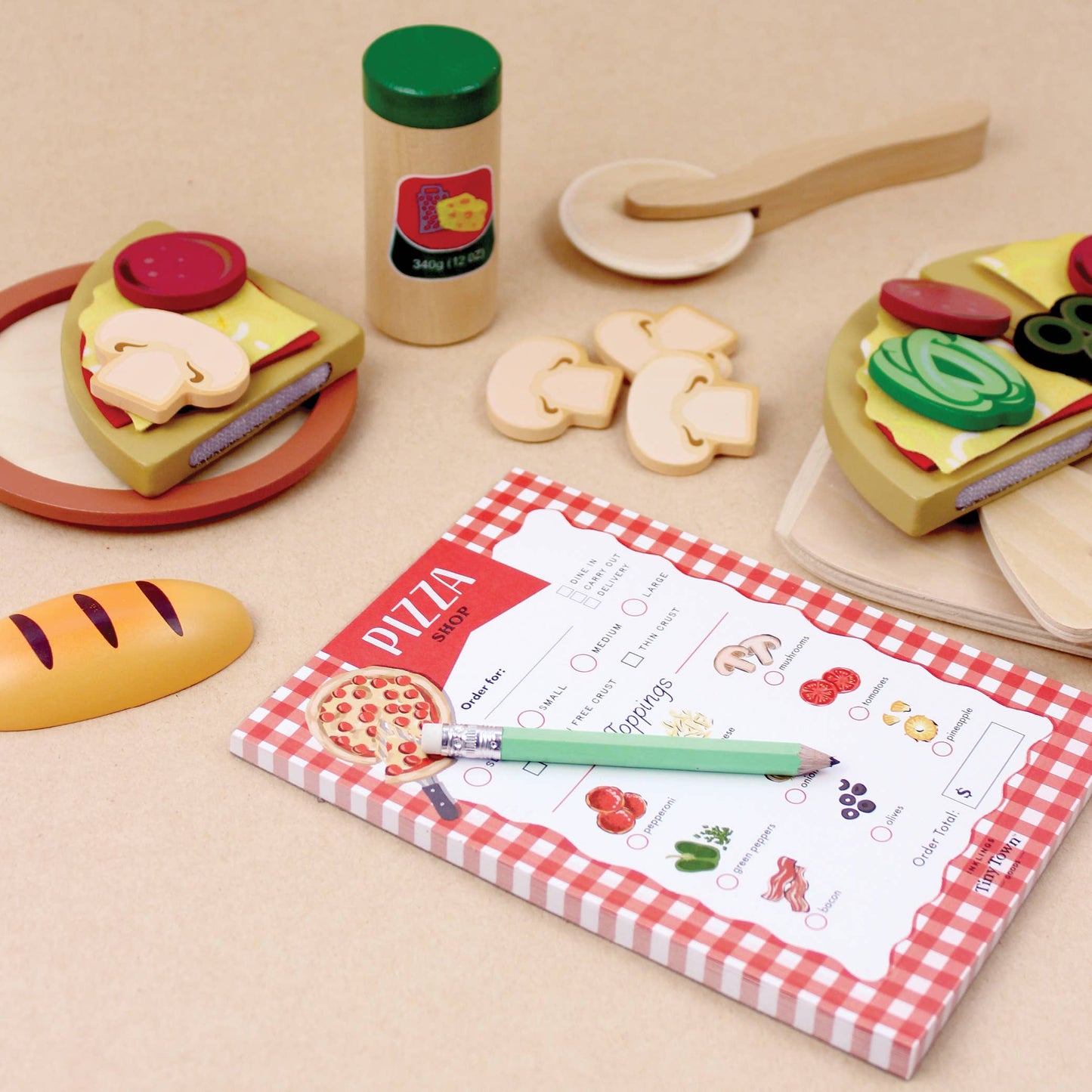 Pizza ordering sheet pretend play notepad with toppings and a pen on a white background