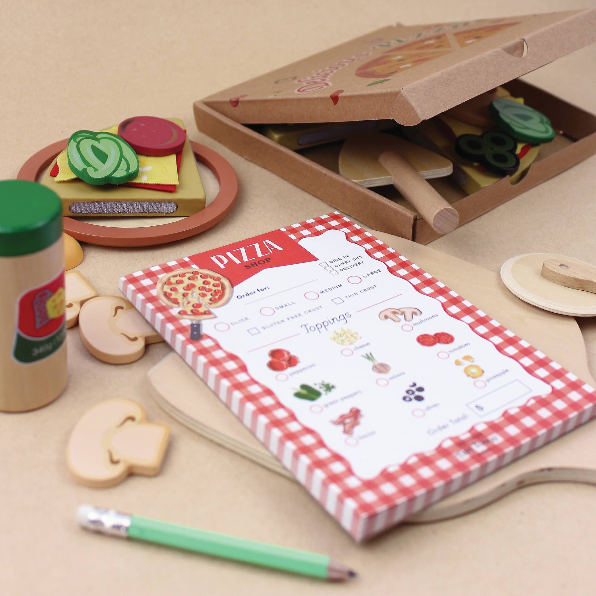 Pizza ordering sheet pretend play notepad with toppings and a pen on a white background