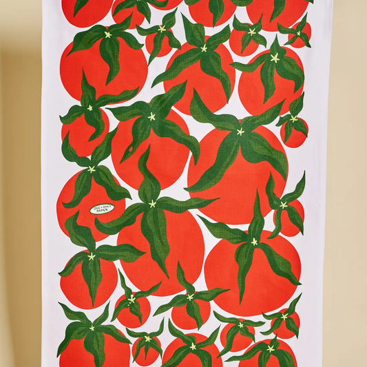 Tea towel with red tomato pattern on a white background