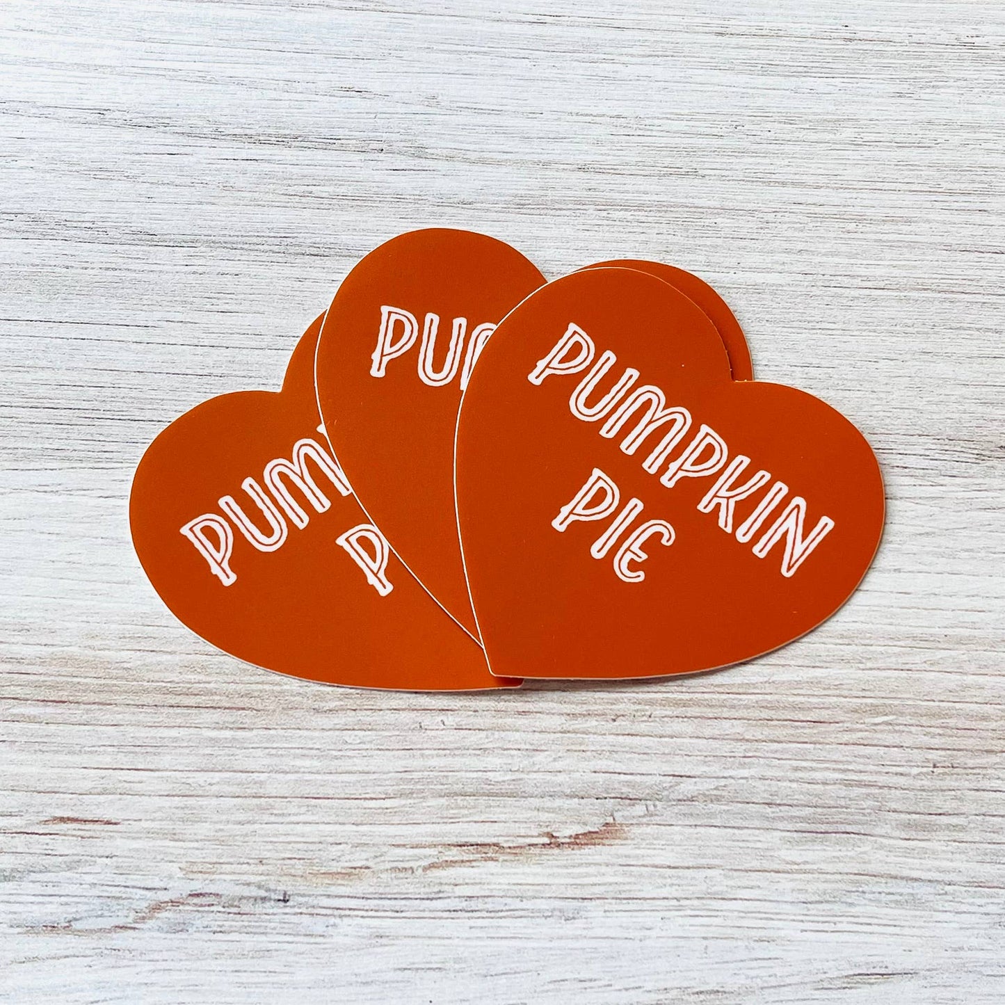 3 heart shaped stickers that are pumpkin pie colored and say: Pumpkin pie