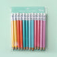 Rainbow mini pencils in a line. Left to right colors: yellow, orange, fuschia, pink, baby blue and teal. Pencils in a clear cellophane package.