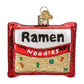 Glass holiday ornament that looks like a package of instant ramen noodles. 