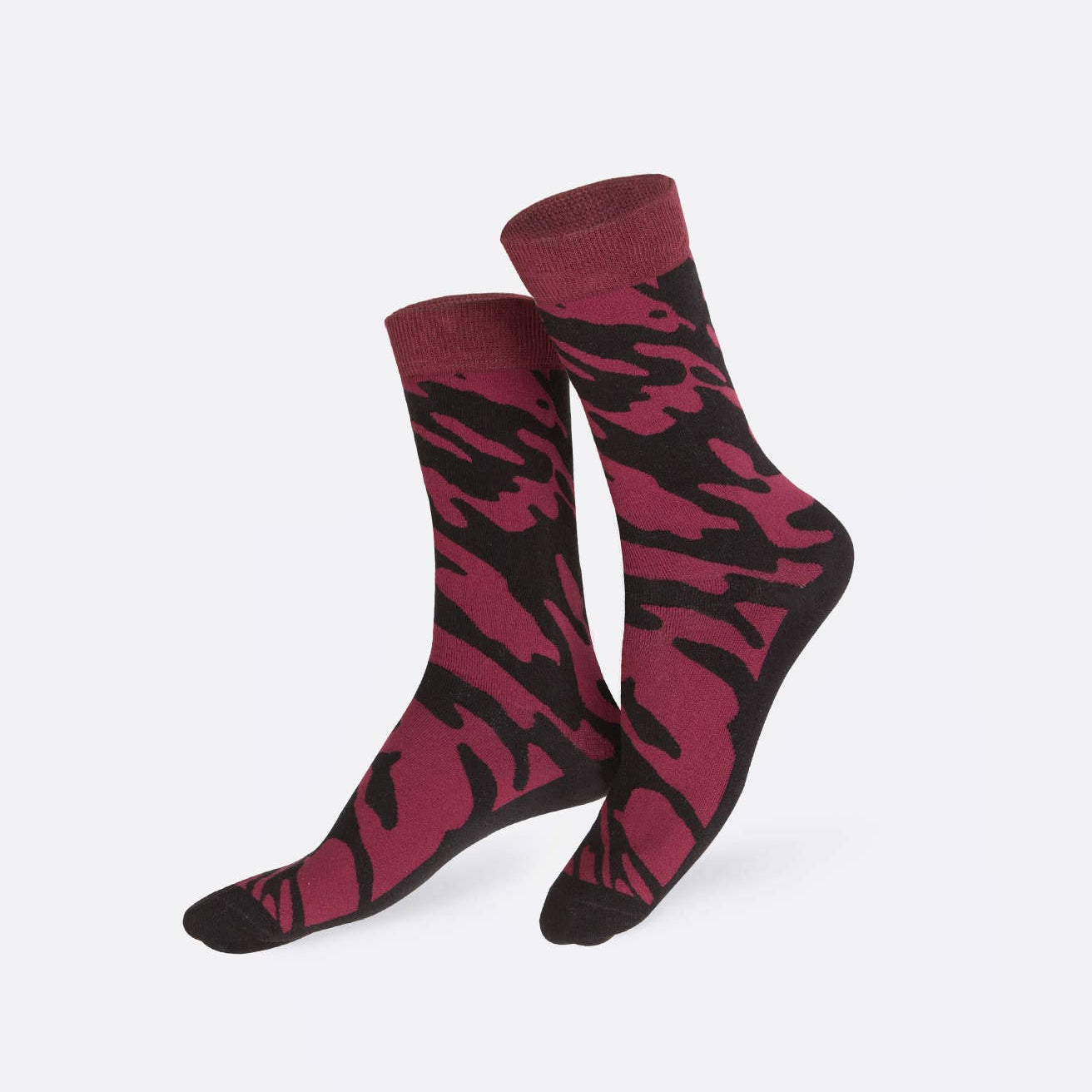 Pair of maroon and black camouflage patterned socks on a white background