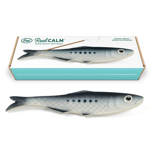 A fish-shaped ceramic stick incense holder and its retail box by Fred Reel Calm, displayed on a clean white background.