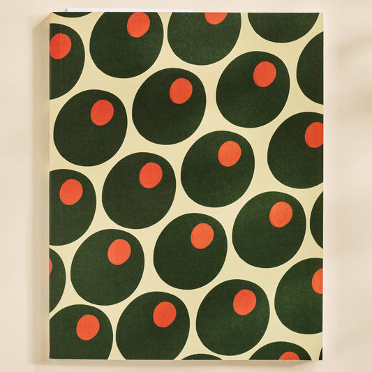 Notebook with green and red circular olive pattern on beige background