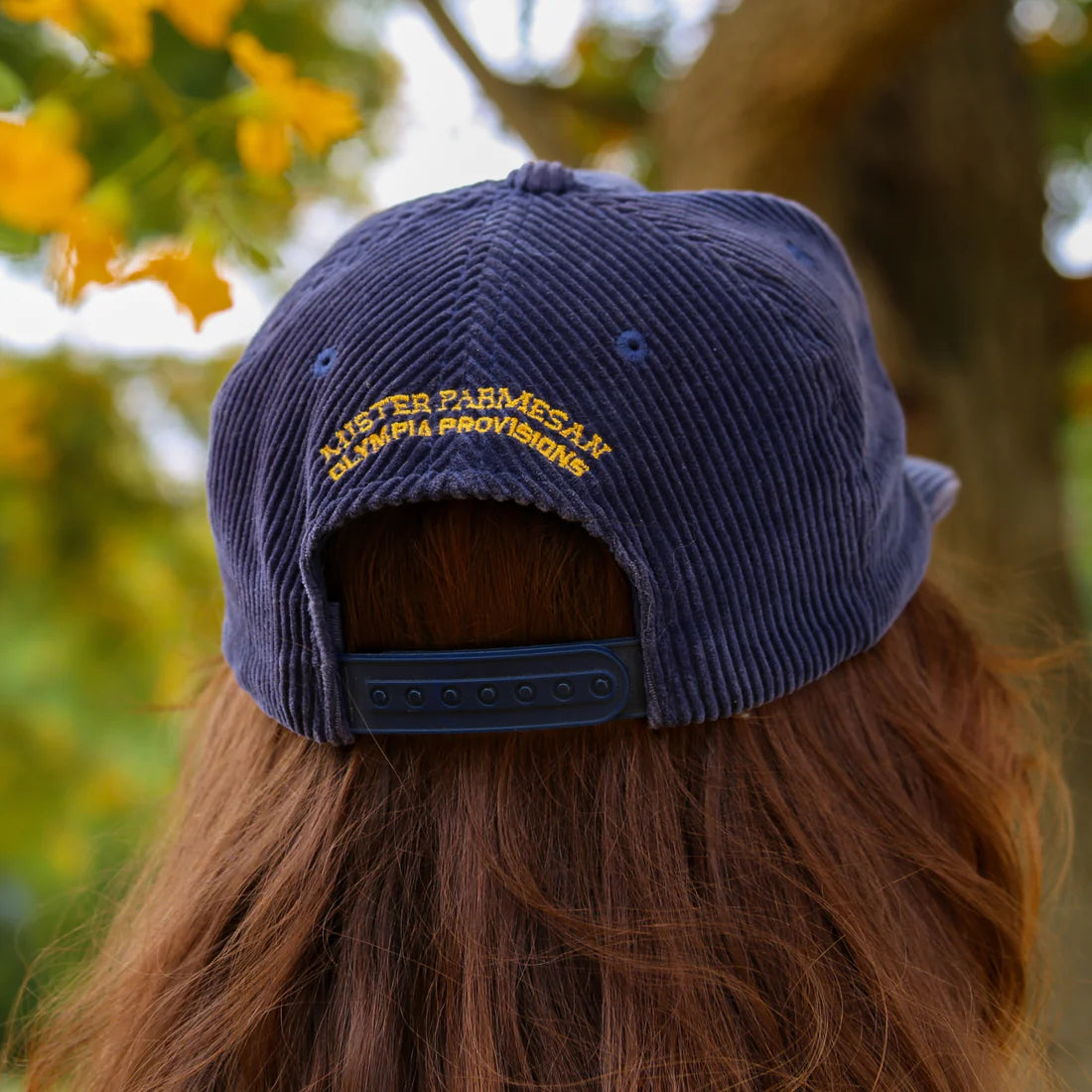Back view - Salami hat with "Mister Parmesan x Olympia Provisions" embroidered in gold.
