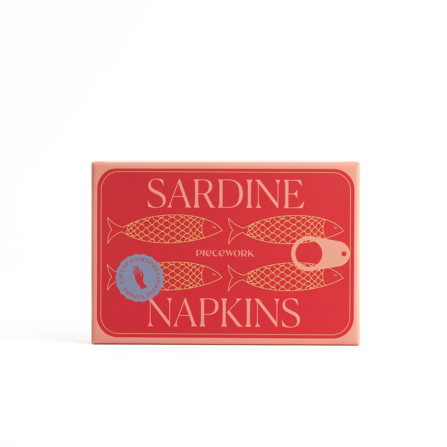 Red and salmon colored box with 4 sardines drawn on the front. The box says Piecework, Sardine Napkins, Set of 4 Linen Cocktail Nap