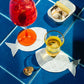 Staged table with sardine napkins with drinks on top of them. sardine tinned can open.