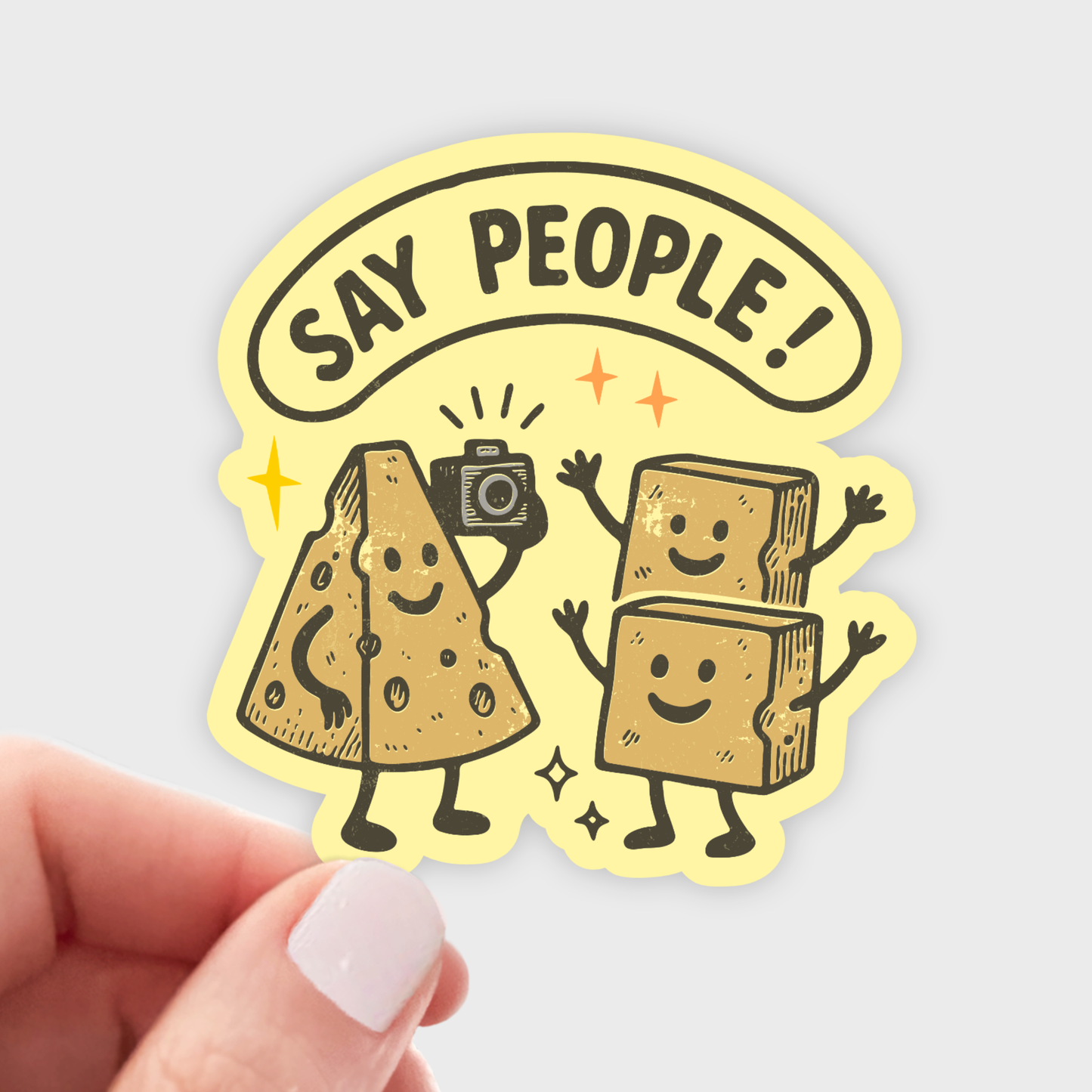 Sticker with cartoon cheese characters and 'Say People!' text held by a hand.