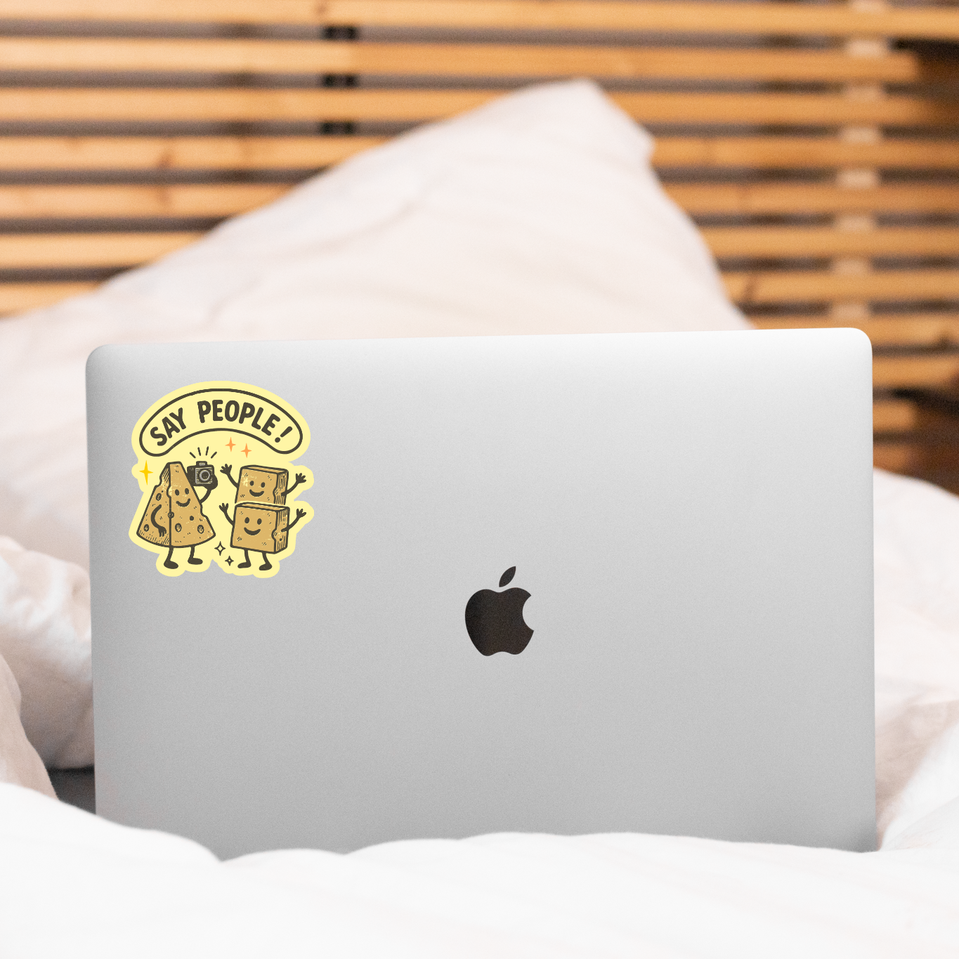 Laptop with a sticker on a bed