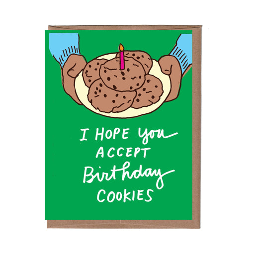 Birthday card that says: I hope you accept birthday cookies. Green card with arms holding a plate of cookies that has a candle in it.