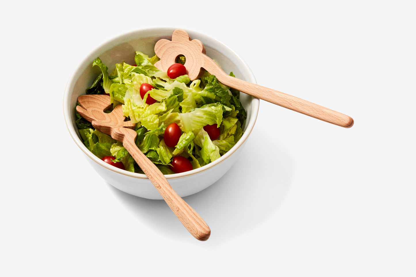 flower shaped serving spoons in salad bowl 