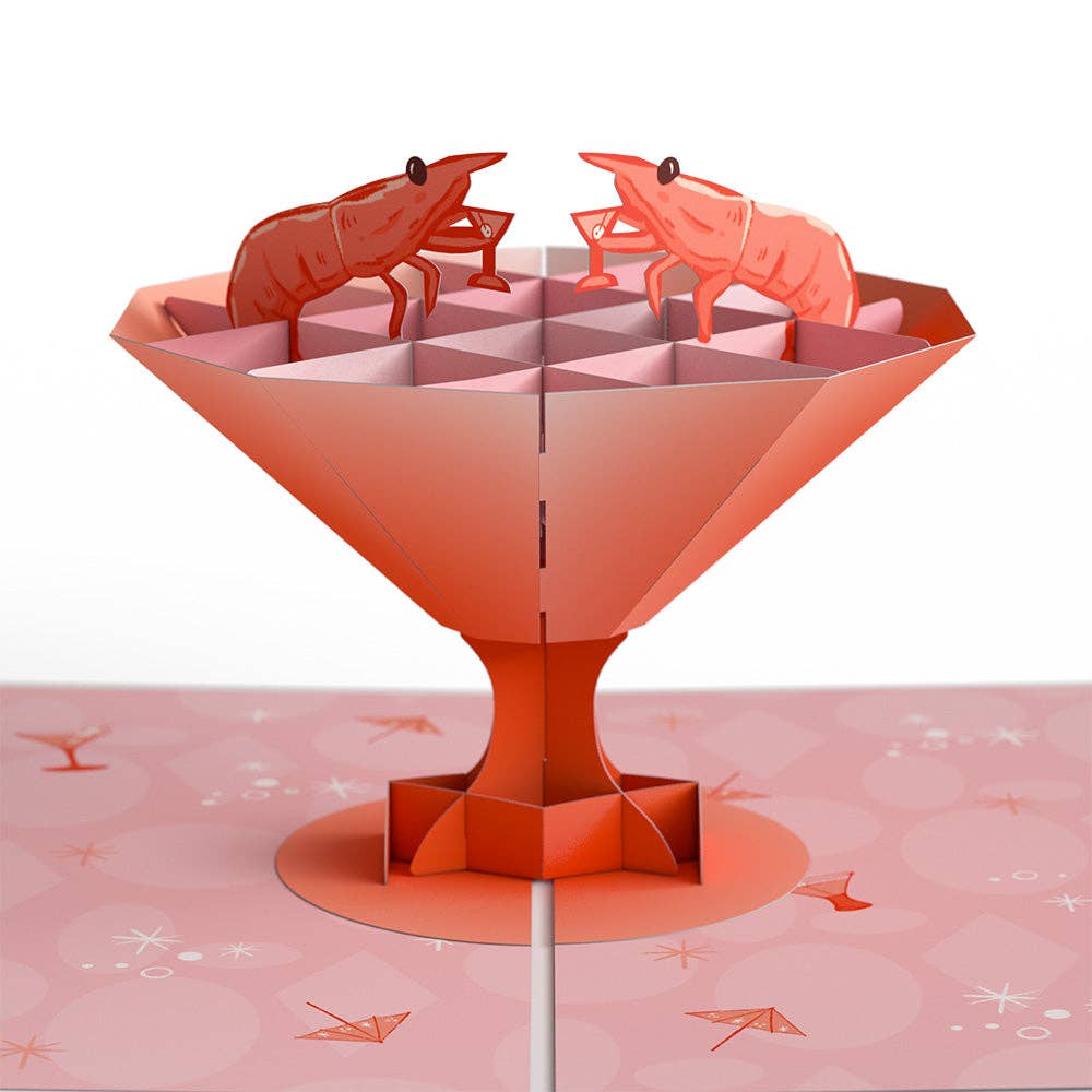 Pop up die-cut card revelaing 2 shrimp sitting inside of the cocktail glass. THe shrimp are holding martini glasses.