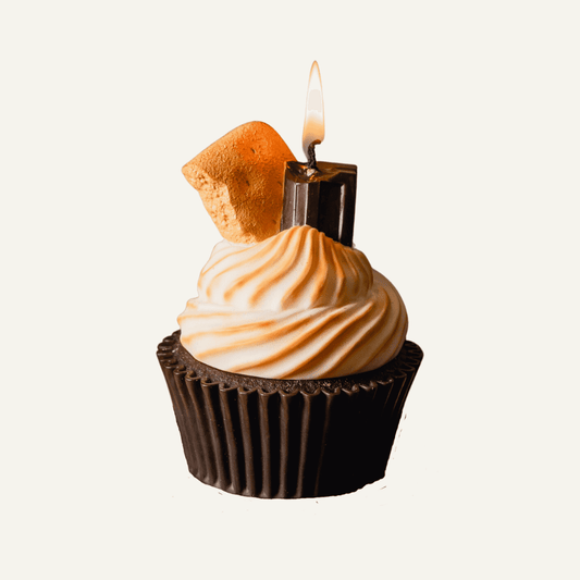 Realistic Smores Candle with chocolate cupcake base, whipped marshmallow topping and topped with a piece of chocolate and piece of graham cracker.