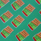Pattern of 'Snack More, Stress Less' stickers  on a green background