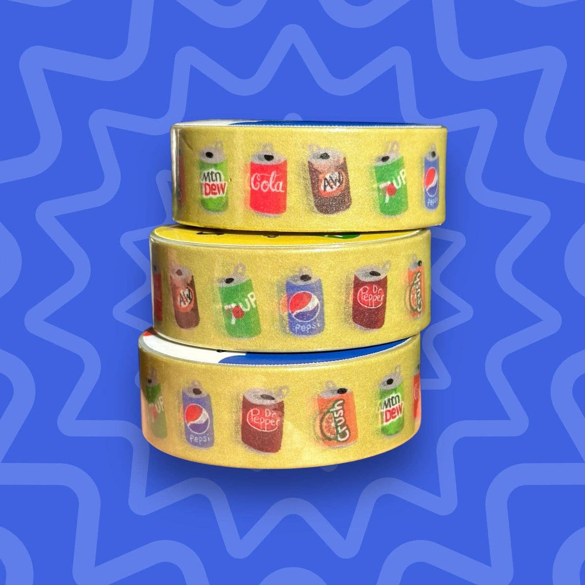 Three rolls of yellow washi tape with soda can designs on a blue wavy background