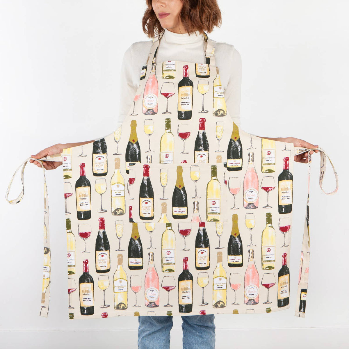 Person wearing an apron with wine bottle and glass pattern