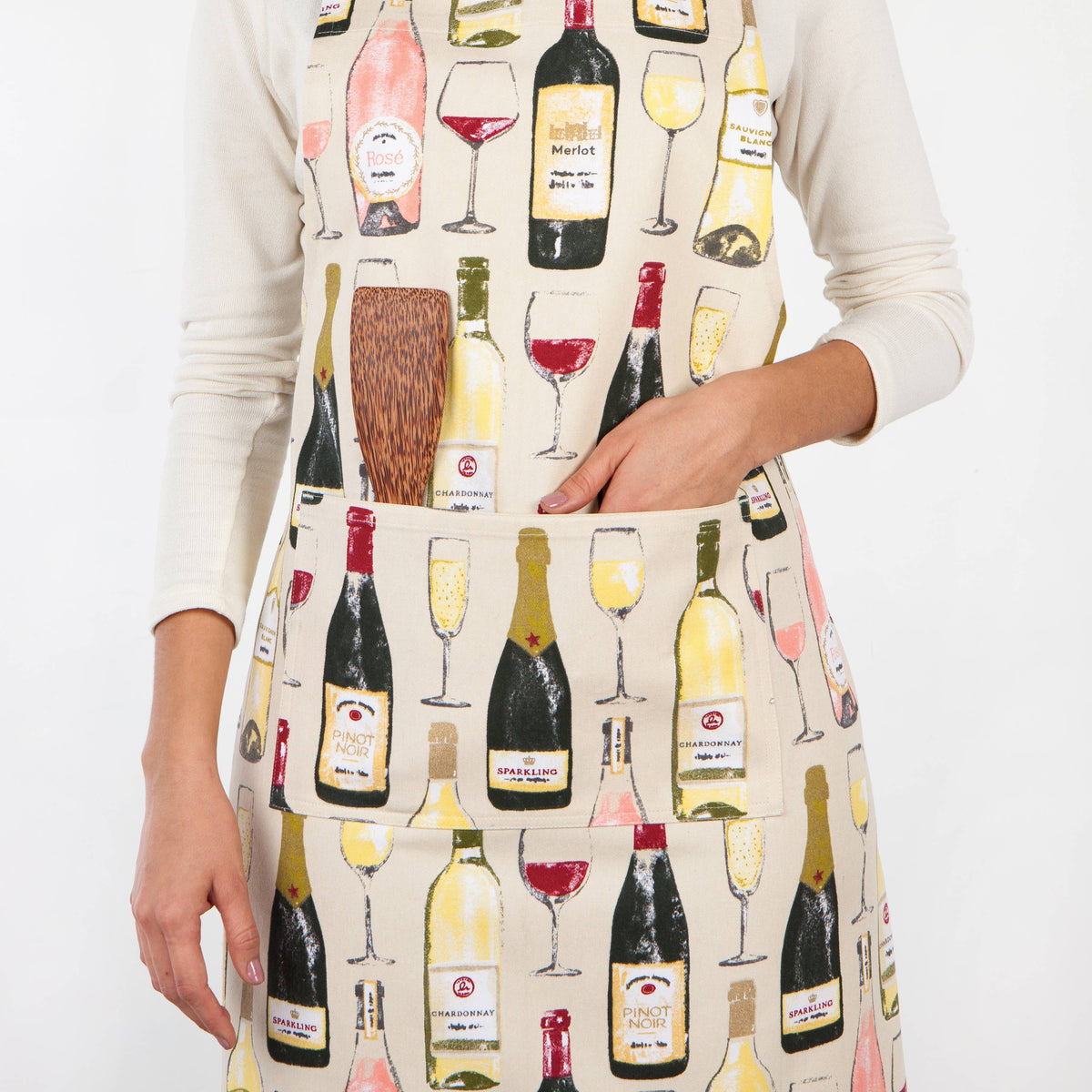Person wearing an apron with wine-themed design on a white background