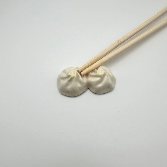 Soup Dumpling Chopstick Rest with Chopsticks on it.