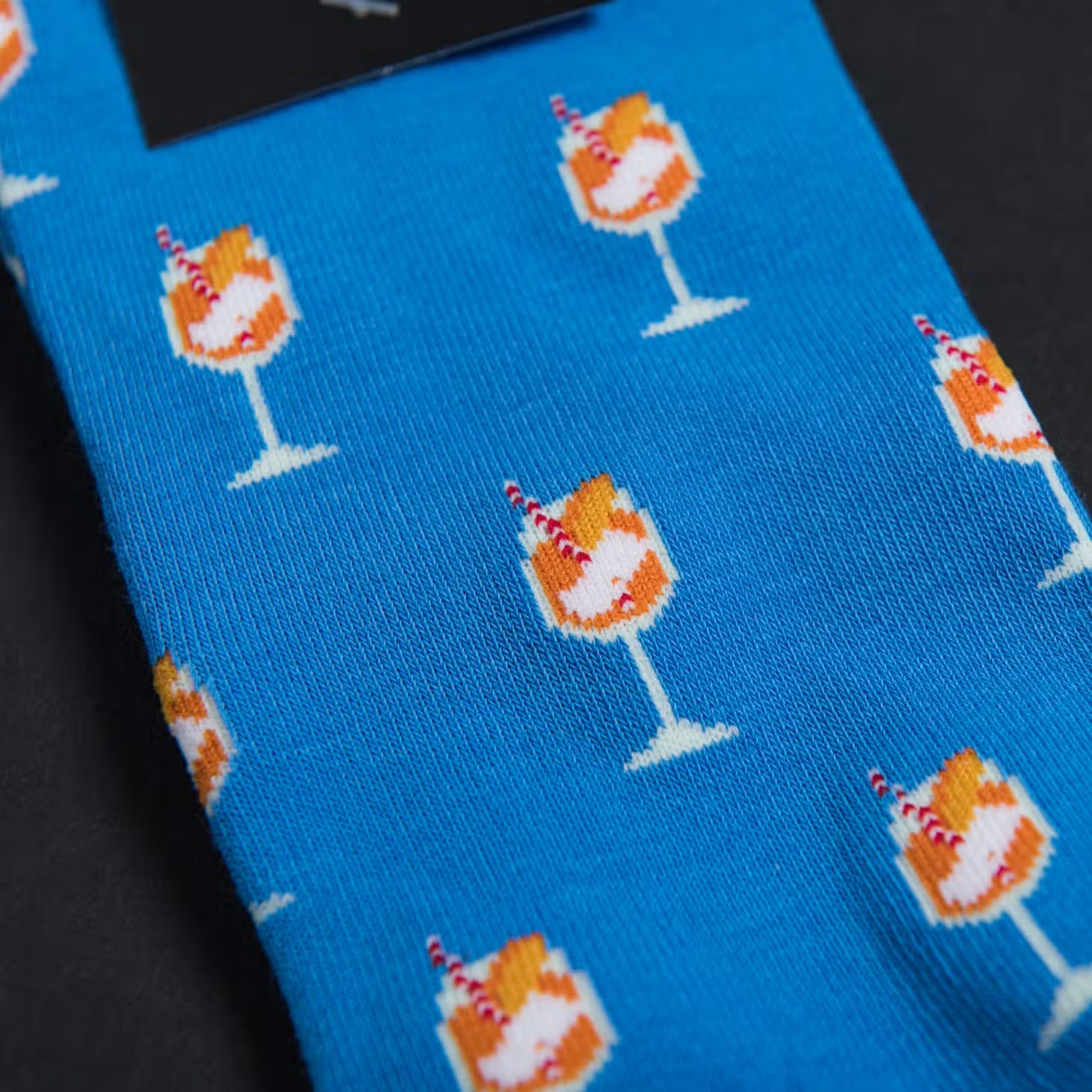 Aperol Spritz patterned socks on blue socks