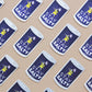 Pattern of 'Stay Salty' salt shaker stickers on a beige background