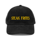 Black cap with 'STEAK FRITES' text in yellow on a transparent background