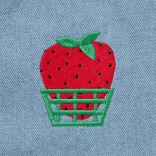 Blue apron with red straps. This apron is dedicated to strawberries with embroidery of strawberries in a basket and on a vine with little white flowers.