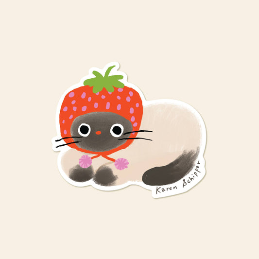 Sticker of an illustrated black and white cat wearing a strawberry design hat 