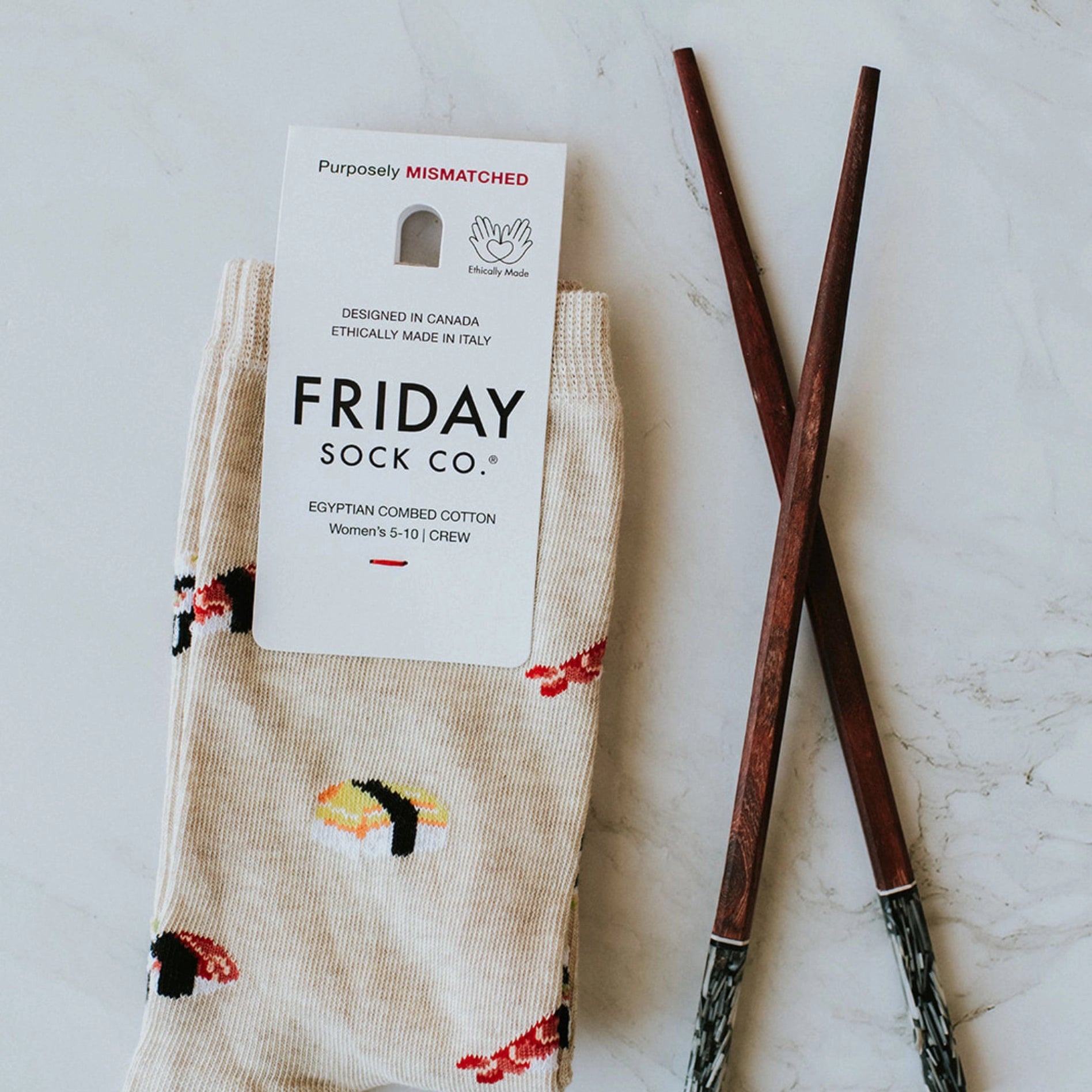 Friday socks Sushi print with chopsticks next to it for decor.