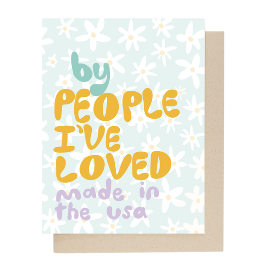 Back of greeting card with text 'by people I've loved made in the USA' on a floral background