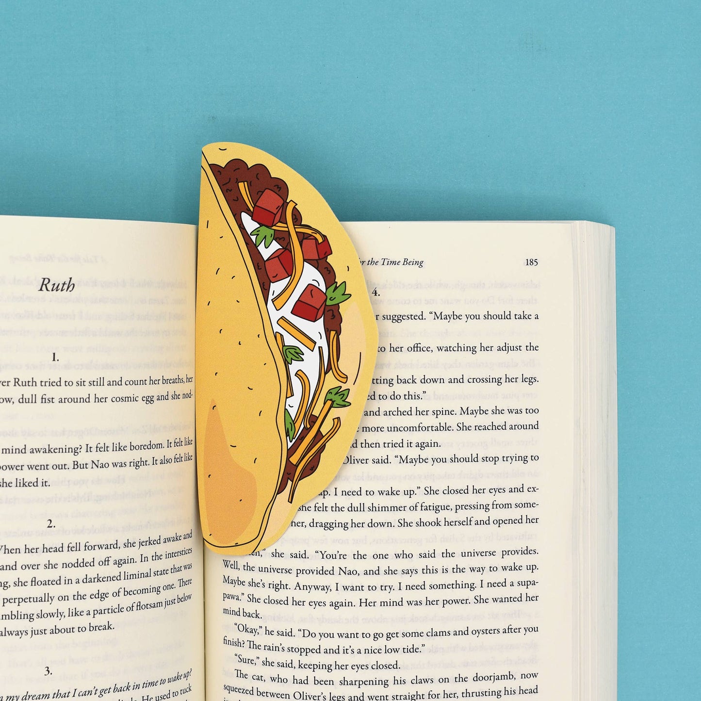 Bookmark shaped like a hardshell taco shown inside an open book.